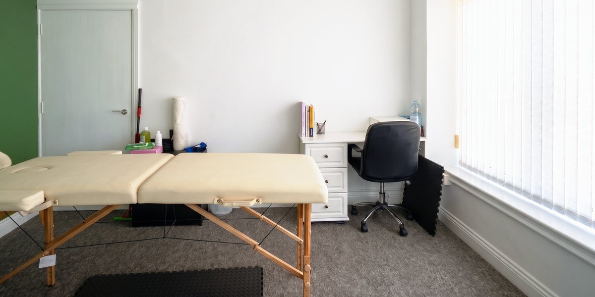 The treatment room at Fit Physiotherapy on Roumelia Lane, with the treatment couch, desk and window